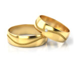 Obrączki ślubne złote półokrągłe z diamentem fala